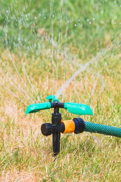 Close up of lawn sprinkler in summer day — Stock Photo, Image