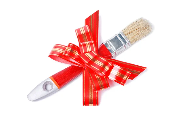 Paintbrush with red bow as a gift for painter — Stock Photo, Image