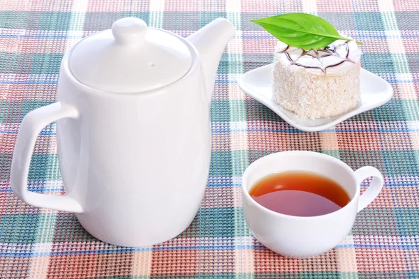 Milk jelly cake with coconut decoration, teapot and a cup of tea — Stock Photo, Image