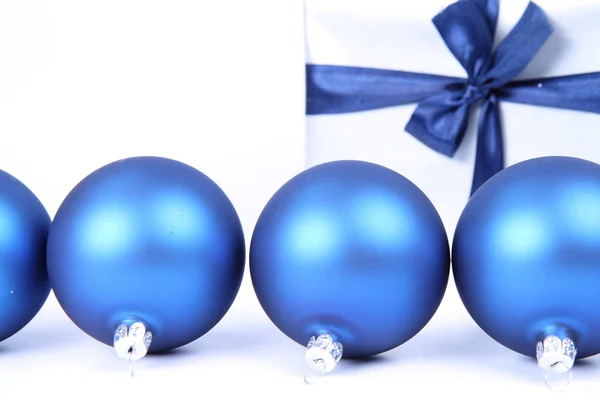 Christmas balls and a gift Royalty Free Stock Photos