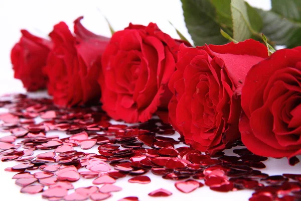 Red roses and confetti — Stock Photo, Image