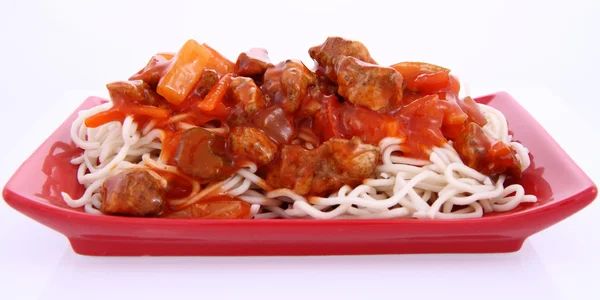 stock image Chinese food - sweet and sour chicken with chow mein noodles