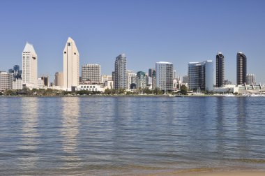 Downtown buildings reflect in the water of San Diego Bay. clipart