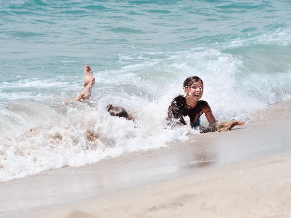 Stock image Children in the waves