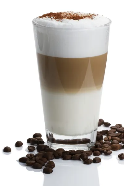 Latte macchiato with cocoa and beans on white — Stock Photo, Image