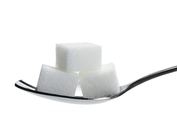 Três caroços de açúcar em uma colher — Fotografia de Stock