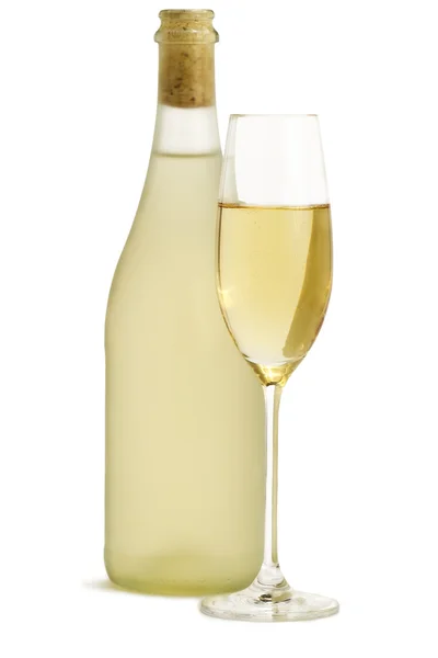 Sklenka šampaňského před stojící láhev Prosecca — Stock fotografie