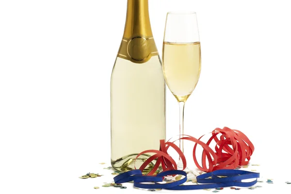 Kieliszek szampana z blow out i konfetti przed szampana bott — Zdjęcie stockowe