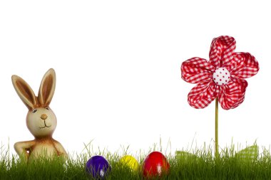 Easter bunny behind grass with drapery flower and easter eggs clipart