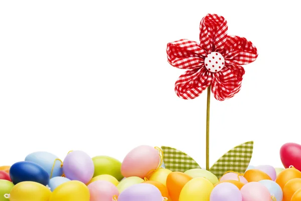 Red drapery flower between easter eggs — Stock Photo, Image