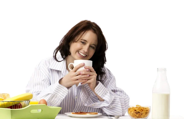 Young laughing woman at breakfast — Stock Photo, Image