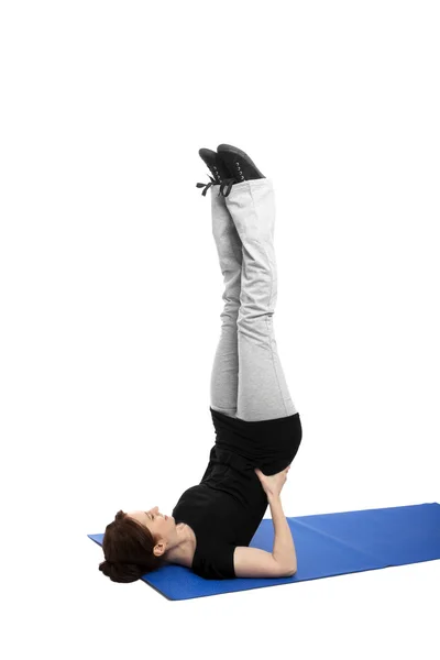 Young woman doing shoulder stand — Stock Photo, Image