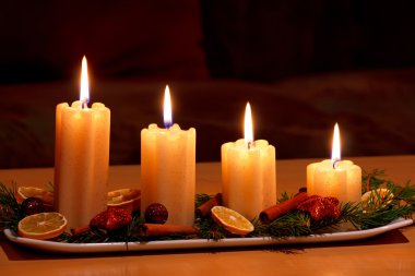 Christmas decorated table with lighting candles clipart