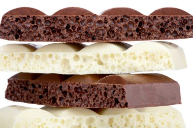 Stack of brown and white porous chocolate isolated on the white clipart