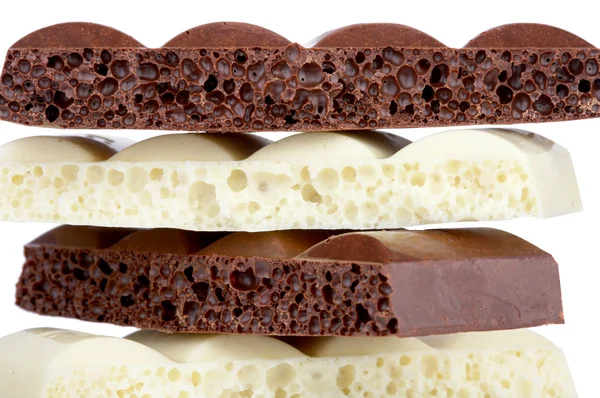 stock image Stack of brown and white porous chocolate isolated on the white