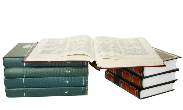 Open book on stack of books against white background. — Stock Photo, Image