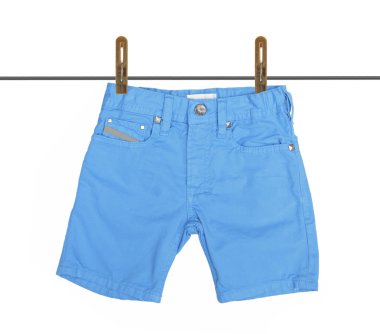 Blue jeans shorts with drying on clothesline isolated on the white background with clipping path. clipart