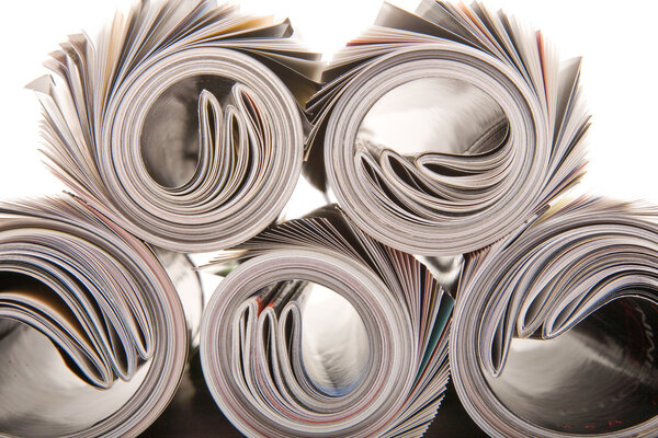 Background of rolled magazines against white