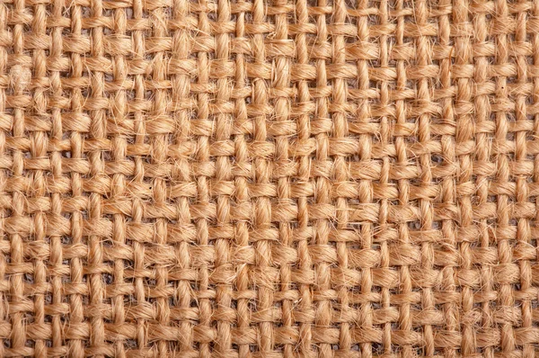 自然の黄麻布のヘシアン解任のクローズ アップ 黄麻布素材を使用してバック グラウンド テクスチャ — ストック写真