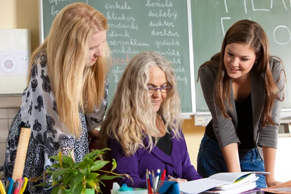 Female teacher and students — Stock Photo, Image