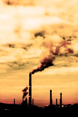 Global warming concept in sepia.Pollution smoke from factory clipart