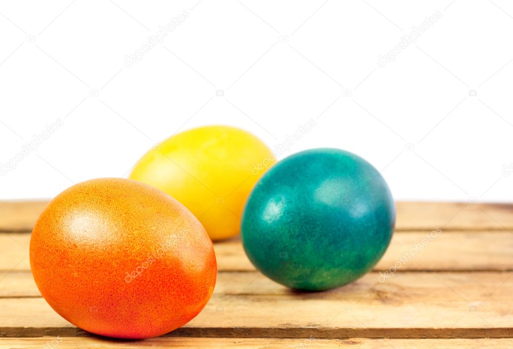 Easter eggs on wooden floor over white background