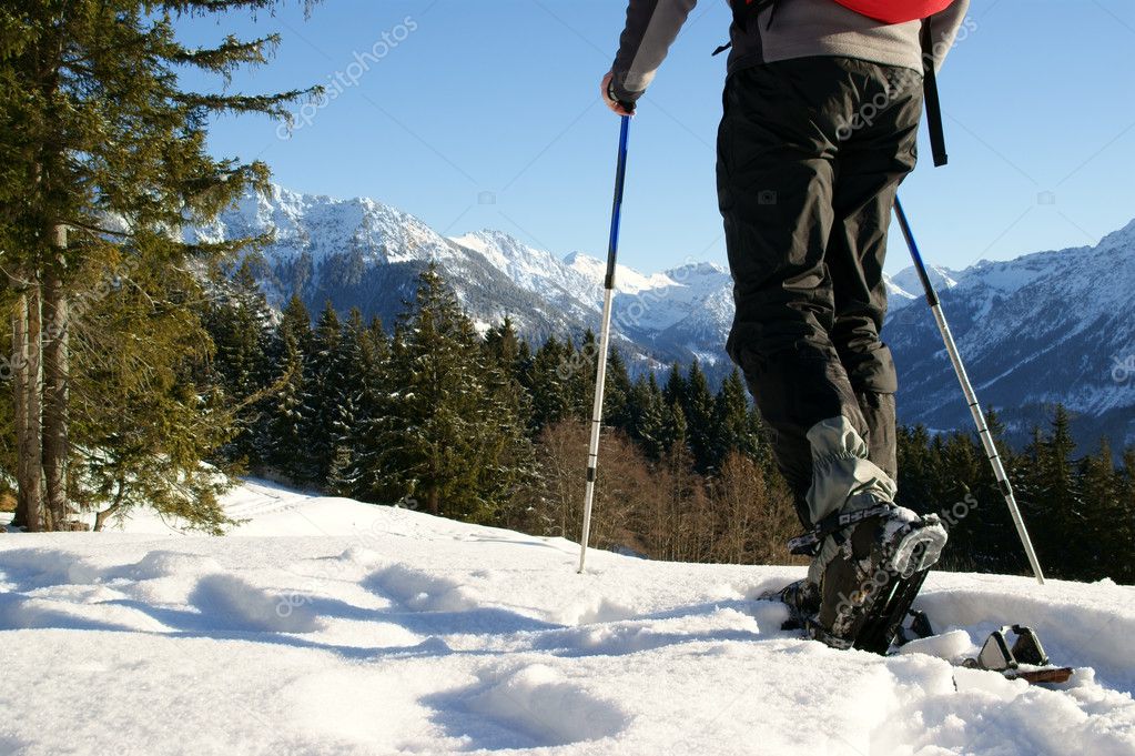 A man makes a snowshoe tour in a beautiful mountain landscape.