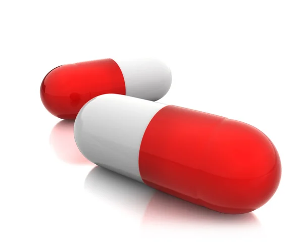 Две красные таблетки — стоковое фото