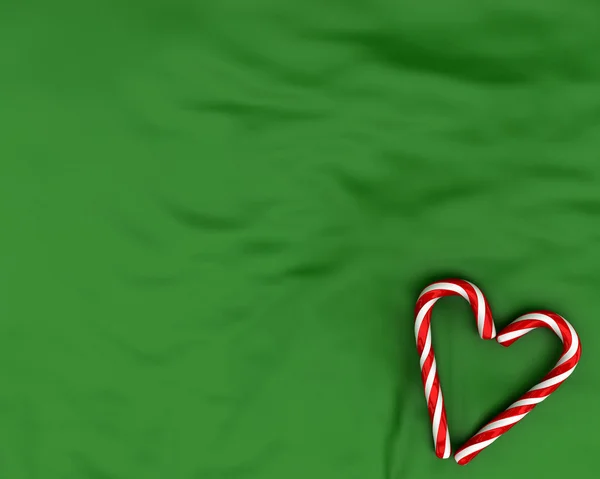 Heart made from christmas candies on green background — Stock Photo, Image