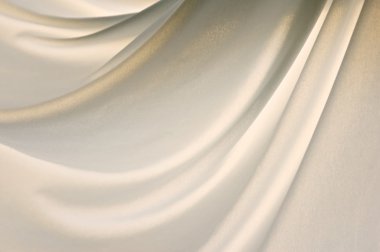 A light soft nylon cloth is gently draped creating folds in this back lit image. clipart