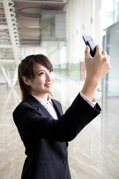 Businesswoman taking picture by camera — Stock Photo, Image