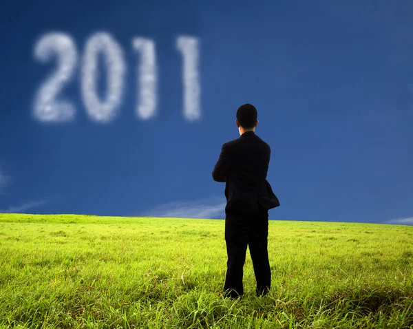 Affärsman tänker och tittar på 2011 — Stockfoto