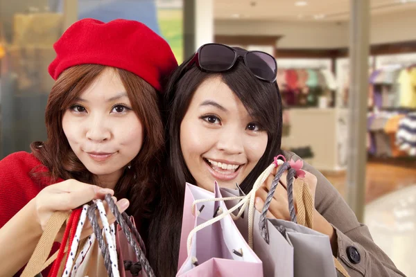 Happy girls in a shopping mall — Stock Photo, Image