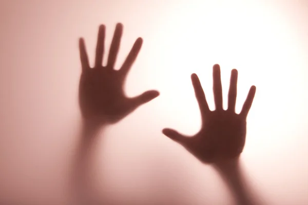 Hand reaching out and touching glass — Stock Photo, Image