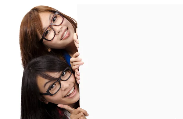 Smiling and Beautiful Girls behind the white board — Stock Photo, Image