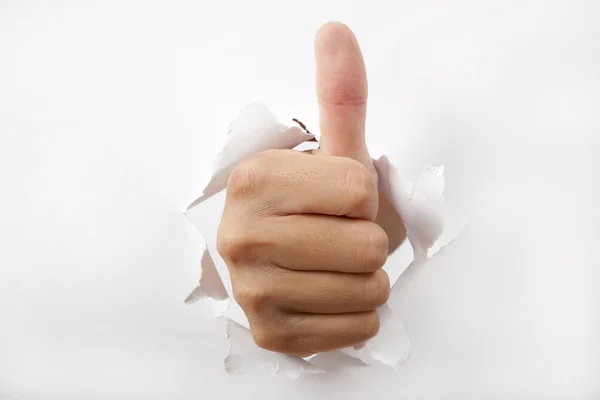 Hand break through the white paper with Thumb up — Stock Photo, Image