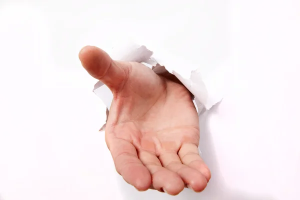 Mão perfurando através de papel branco — Fotografia de Stock