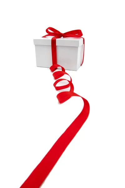 Red ribbon and white gift box — Stock Photo, Image