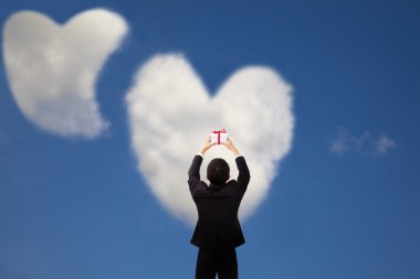 Man holding gift and two heart and love cloud clipart