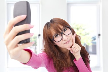 Young asian woman take photo by her cell phone clipart