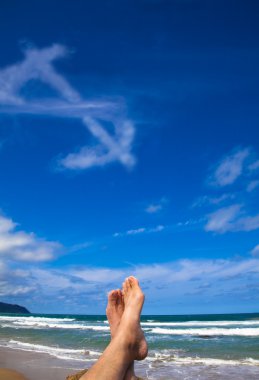Lying on the beach with dollar symbol cloud clipart