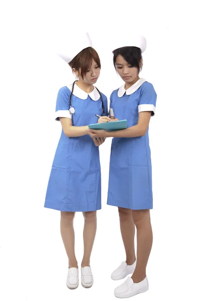 Two Nurses Team Reading Clipboard Isolated White Backgroung — Stock Photo, Image