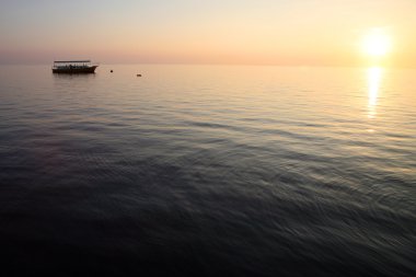 Sunset and the ship in the maldives clipart