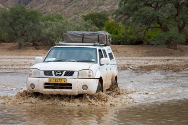 Crossing of a river by 4x4 clipart