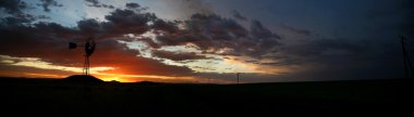 Silhouette of Farm Windmill at Sunset clipart