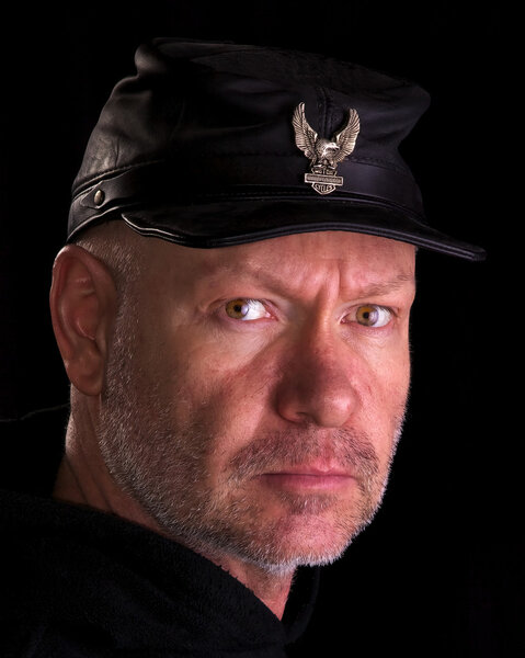 Biker wearing a black civil war cap with eagle emblem