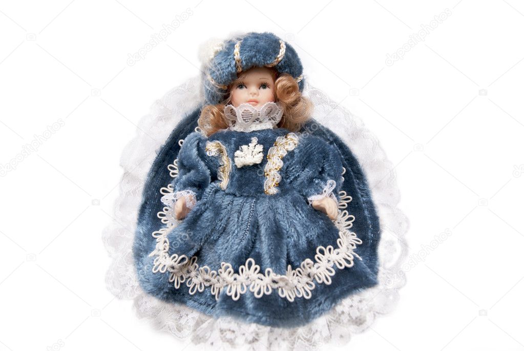 Doll dressed in a vintage dress of blue-gold
