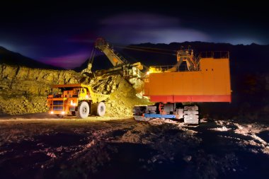 A picture of a big yellow mining truck at worksite (night) clipart