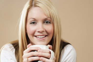 Beautiful blond drinking from a cup clipart