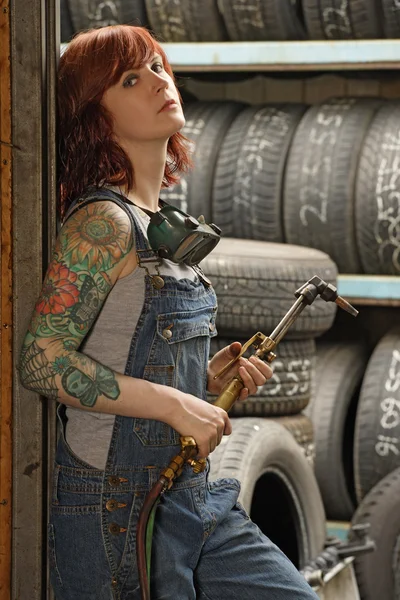 stock image Female welder with tattoos